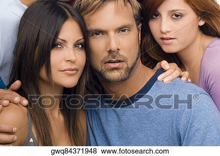 Portrait of a mid adult man with two young women View Large Photo Image Stock Photo - Portrait of a mid adult man with two young women. Fotosearch