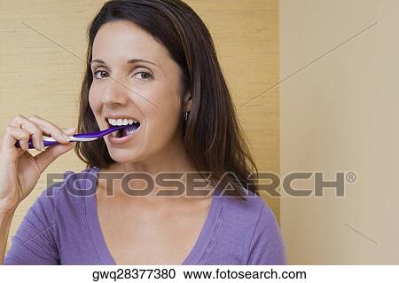 Portrait of a mid adult woman brushing her teeth View Large Photo Image Stock Image - Portrait of a mid adult woman brushing her teeth. Fotosearch