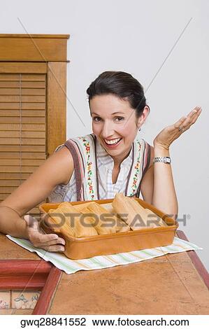 Portrait of a mid adult woman laughing with a tray of breads in the kitchen View Large Photo Image Stock Image - Portrait of a mid adult woman laughing with a tray of breads in the kitchen. Fotosearch