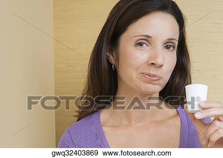 Portrait of a mid adult woman rinsing her mouth with mouthwash View Large Photo Image Stock Photo - Portrait of a mid adult woman rinsing her mouth with mouthwash. Fotosearch