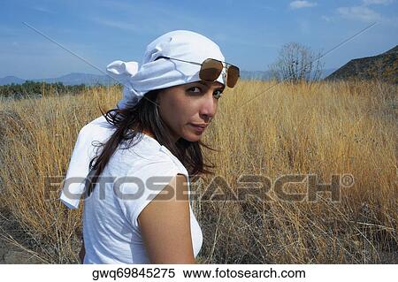 Portrait of a mid adult woman standing in a field View Large Photo Image Stock Photography - Portrait of a mid adult woman standing in a field. Fotosearch