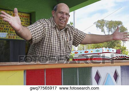 Portrait of a senior man standing with his arms outstretched View Large Photo Image Stock Photo - Portrait of a senior man standing with his arms outstretched. Fotosearch