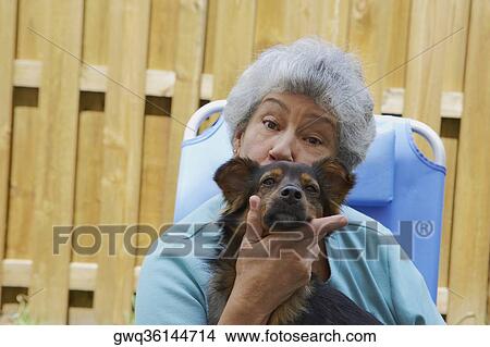 Portrait of a senior woman kissing a dog View Large Photo Image Picture - Portrait of a senior woman kissing a dog. Fotosearch
