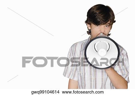 Picture - Portrait of a teenage boy blowing a bullhorn. Fotosearch
