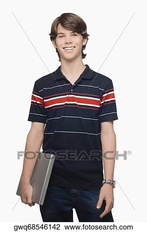 Portrait of a teenage boy holding a laptop and smiling View Large Photo Image Stock Image - Portrait of a teenage boy holding a laptop and smiling. Fotosearch