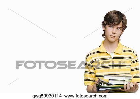 Portrait of a teenage boy holding books and ring binders View Large Photo Image Picture - Portrait of a teenage boy holding books and ring binders. Fotosearch