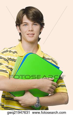 Portrait of a teenage boy holding books and ring binders View Large Photo Image Stock Image - Portrait of a teenage boy holding books and ring binders. Fotosearch