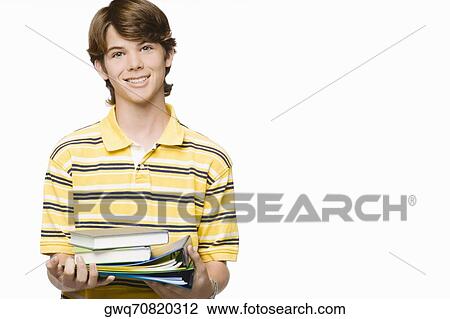 Portrait of a teenage boy holding books and ring binders View Large Photo Image Stock Image - Portrait of a teenage boy holding books and ring binders. Fotosearch