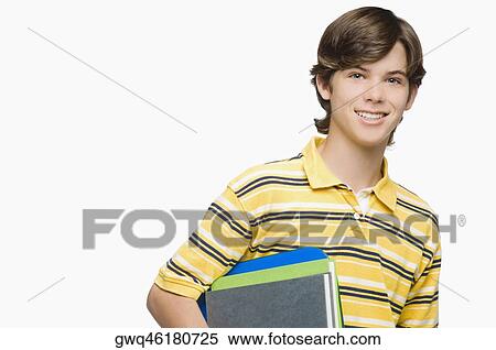 Portrait of a teenage boy holding books and ring binders View Large Photo Image Stock Photography - Portrait of a teenage boy holding books and ring binders. Fotosearch