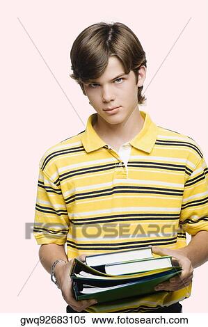 Portrait of a teenage boy holding books and ring binders View Large Photo Image Stock Photography - Portrait of a teenage boy holding books and ring binders. Fotosearch