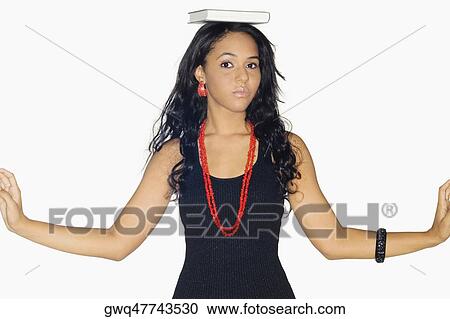 Portrait of a teenage girl with a book on her head View Large Photo Image Stock Image - Portrait of a teenage girl with a book on her head. Fotosearch