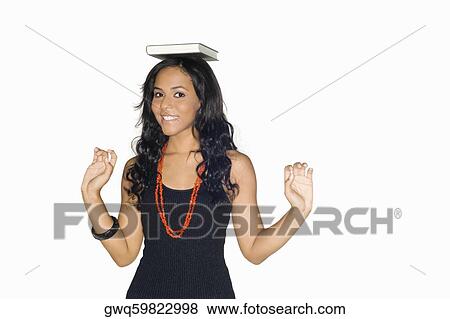 Portrait of a teenage girl with a book on her head View Large Photo Image Stock Photo - Portrait of a teenage girl with a book on her head. Fotosearch