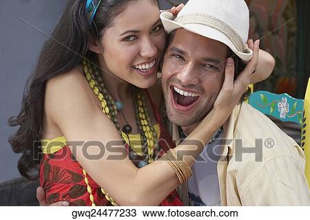 Portrait of a young couple embracing each other and smiling View Large Photo Image Stock Image - Portrait of a young couple embracing each other and smiling. Fotosearch
