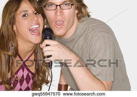 Portrait of a young couple singing together View Large Photo Image Stock Image - Portrait of a young couple singing together. Fotosearch