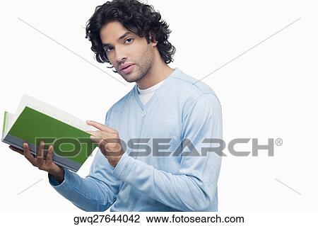 Stock Image - Portrait of a young man holding a book. Fotosearch