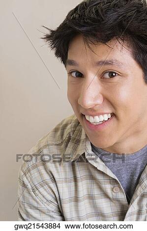 Portrait of a young man smiling View Large Photo Image Picture - Portrait of a young man smiling. Fotosearch