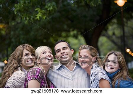 Portrait of a young man smiling with four young women View Large Photo Image Stock Photo - Portrait of a young man smiling with four young women. Fotosearch