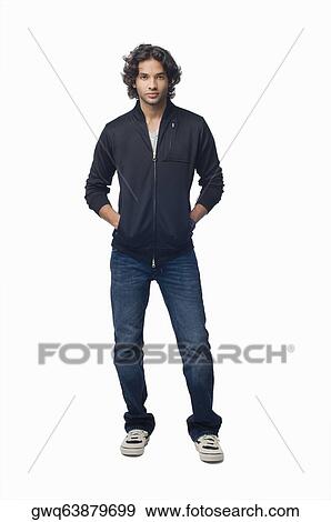 Portrait of a young man standing with his hands in his pockets View Large Photo Image Stock Photo - Portrait of a young man standing with his hands in his pockets. Fotosearch
