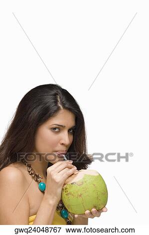 Portrait of a young woman drinking coconut milk View Large Photo Image Stock Photo - Portrait of a young woman drinking coconut milk. Fotosearch