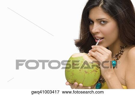 Portrait of a young woman drinking coconut milk View Large Photo Image Stock Photo - Portrait of a young woman drinking coconut milk. Fotosearch