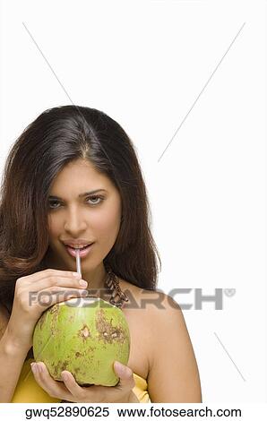 Portrait of a young woman drinking coconut milk View Large Photo Image Stock Photography - Portrait of a young woman drinking coconut milk. Fotosearch