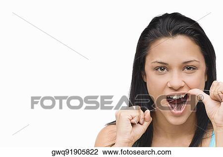 Portrait of a young woman flossing her teeth View Large Photo Image Stock Image - Portrait of a young woman flossing her teeth. Fotosearch
