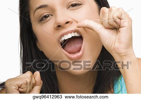 Portrait of a young woman flossing her teeth View Large Photo Image Stock Image - Portrait of a young woman flossing her teeth. Fotosearch