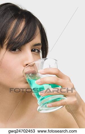 Portrait of a young woman gargling View Large Photo Image Stock Image - Portrait of a young woman gargling. Fotosearch