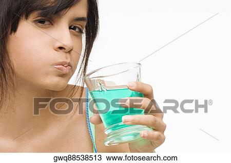 Portrait of a young woman gargling View Large Photo Image Stock Image - Portrait of a young woman gargling. Fotosearch