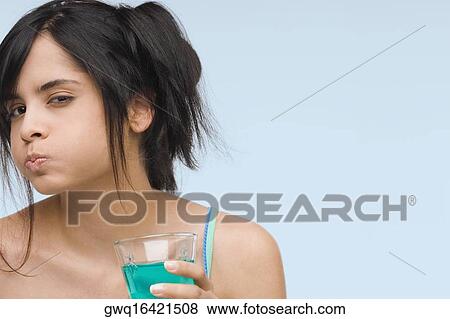 Portrait of a young woman gargling View Large Photo Image Stock Photo - Portrait of a young woman gargling. Fotosearch
