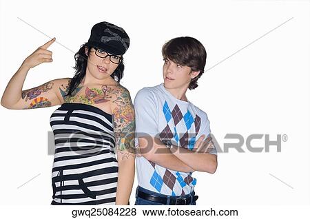 Portrait of a young woman gesturing with a teenage boy standing beside her View Large Photo Image Stock Photo - Portrait of a young woman gesturing with a teenage boy standing beside her. Fotosearch