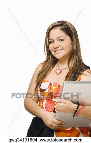 Picture - Portrait of a young woman holding a laptop and smiling. Fotosearch