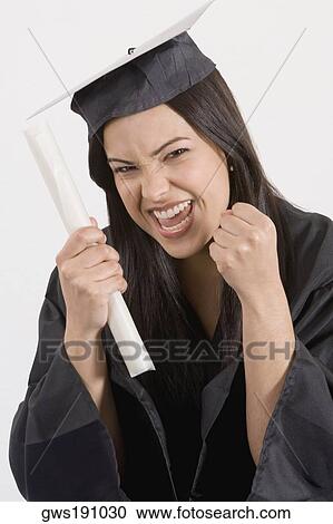 Stock Image - Portrait of a young woman holding a diploma and smiling. Fotosearch