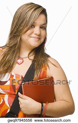 Portrait of a young woman holding a diary and smiling View Large Photo Image Stock Photograph - Portrait of a young woman holding a diary and smiling. Fotosearch