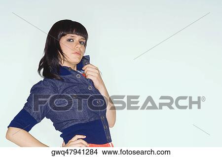Portrait of a young woman holding her collar View Large Photo Image Picture - Portrait of a young woman holding her collar. Fotosearch