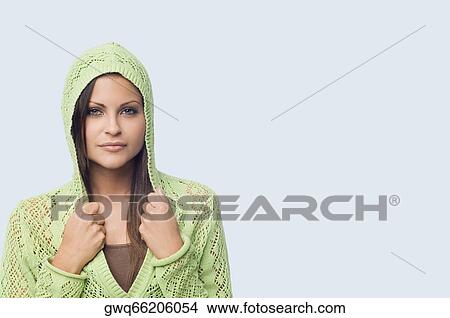 Portrait of a young woman holding collars of her hooded shirt View Large Photo Image Picture - Portrait of a young woman holding collars of her hooded shirt. Fotosearch