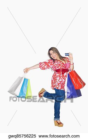 Portrait of a young woman holding shopping bags and dancing View Large Photo Image Stock Photography - Portrait of a young woman holding shopping bags and dancing. Fotosearch