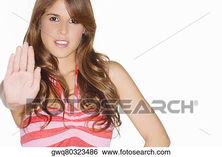 Portrait of a young woman making a stop gesture View Large Photo Image Stock Photograph - Portrait of a young woman making a stop gesture. Fotosearch