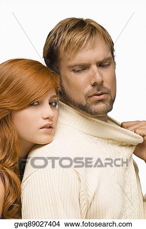 Portrait of a young woman resting her face on the shoulder of a mid adult man View Large Photo Image Picture - Portrait of a young woman resting her face on the shoulder of a mid adult man. Fotosearch