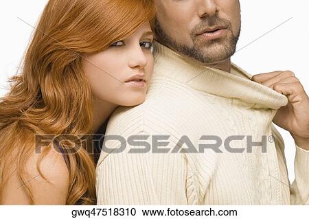 Portrait of a young woman resting her face on the shoulder of a mid adult man View Large Photo Image Stock Image - Portrait of a young woman resting her face on the shoulder of a mid adult man. Fotosearch
