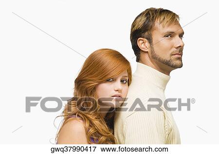 Portrait of a young woman resting her face on the shoulder of a mid adult man View Large Photo Image Stock Photo - Portrait of a young woman resting her face on the shoulder of a mid adult man. Fotosearch