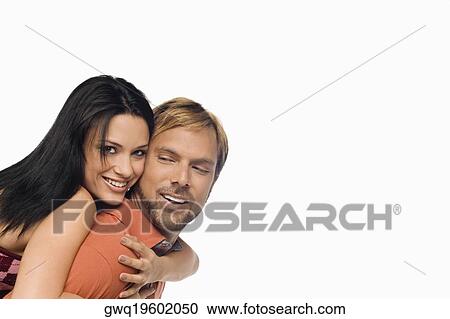 Portrait of a young woman riding piggyback on a mid adult man View Large Photo Image Stock Image - Portrait of a young woman riding piggyback on a mid adult man. Fotosearch