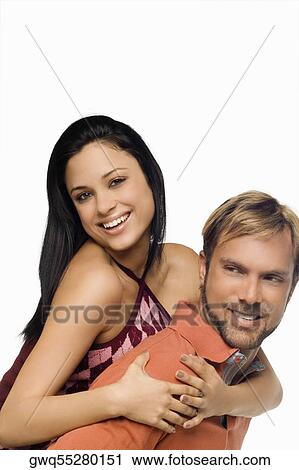 Portrait of a young woman riding piggyback on a mid adult man View Large Photo Image Stock Image - Portrait of a young woman riding piggyback on a mid adult man. Fotosearch