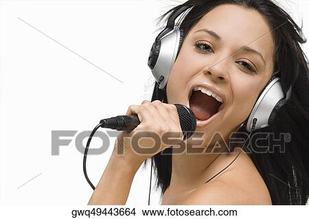 Portrait of a young woman singing into a microphone View Large Photo Image Picture - Portrait of a young woman singing into a microphone. Fotosearch