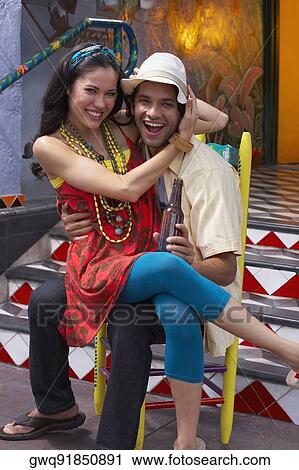 Portrait of a young woman sitting on the lap of a young man View Large Photo Image Stock Image - Portrait of a young woman sitting on the lap of a young man. Fotosearch