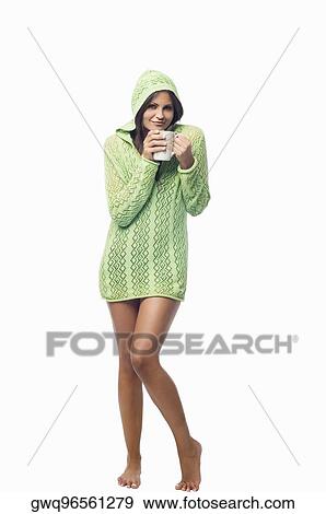 Portrait of a young woman standing and holding a cup of coffee View Large Photo Image Stock Photo - Portrait of a young woman standing and holding a cup of coffee. Fotosearch
