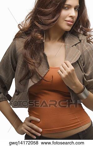 Portrait of a young woman standing with her hand on her hip View Large Photo Image Stock Photo - Portrait of a young woman standing with her hand on her hip. Fotosearch