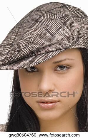 Portrait of a young woman wearing a flat cap View Large Photo Image Stock Image - Portrait of a young woman wearing a flat cap. Fotosearch