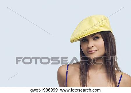 Portrait of a young woman wearing a flat cap and smirking View Large Photo Image Stock Photo - Portrait of a young woman wearing a flat cap and smirking. Fotosearch