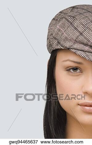 Portrait of a young woman wearing a flat cap View Large Photo Image Stock Photo - Portrait of a young woman wearing a flat cap. Fotosearch